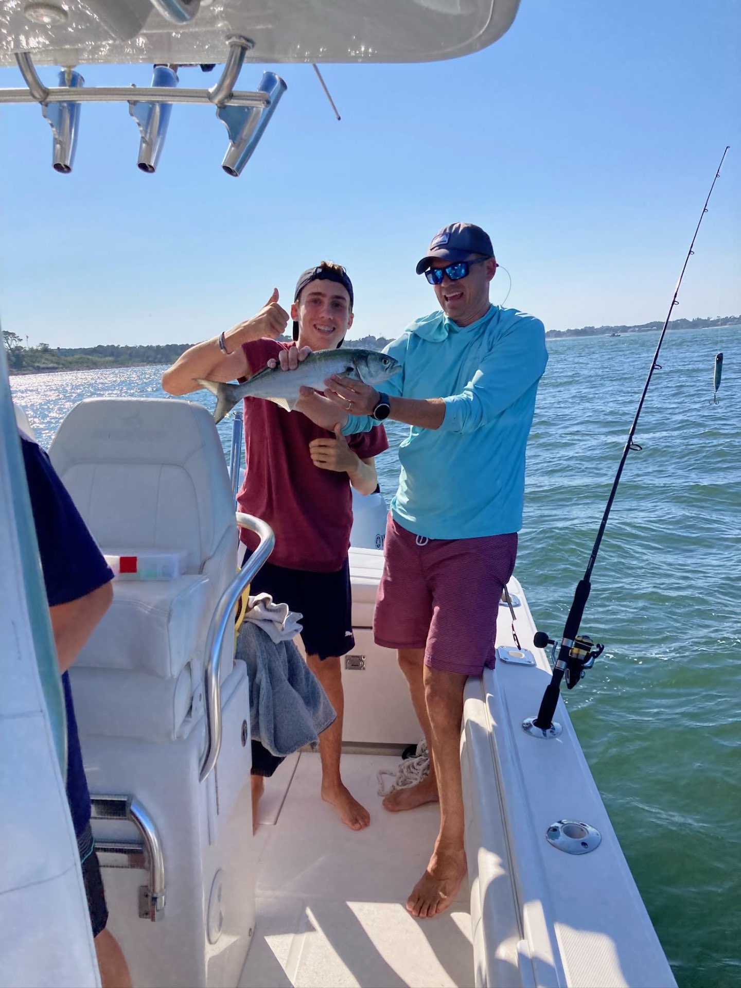 Rob and his son celebrating a bluefish caught on the boat